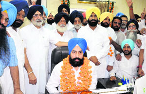 Gurpreet Singh Maluka (centre), flanked by his father, Education Minister Sikandar Singh Maluka, takes charge as the chairman of Zila Parishad in Bathinda on Wednesday. 