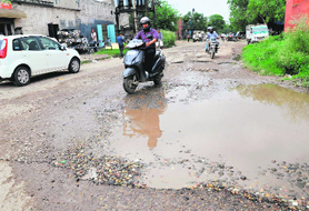 An uncarpeted and potholed road dots the Industrial Area, Phase II, in Chandigarh.