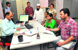 An official listens to the grievances of residents during a lok adalat at the Regional Passport Office in Sector 34