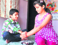 A girl ties rakhi on her brothers wrist in Dehradun on Wednesday. Tribune photo: Vinod Pundir