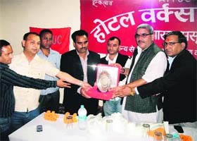 Municipal Council president Manmohan Singh Mall (second from right) felicitates two trade union leaders during a farewell function in Mussoorie