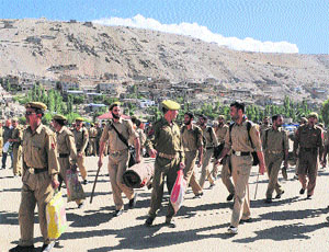 On the eve of elections, police personnel leave for various polling stations from Kargil district headquarters on Wednesday.