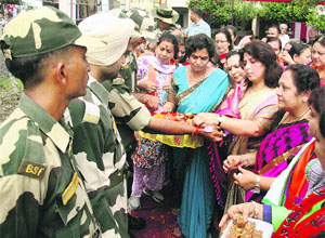 BJP MPs and Mahila Morcha workers tie rakhis to  jawans of 94th Batallion of the BSF at Suchetgarh in Jammu on Wednesday. 