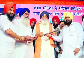 Chief Minister PS Badal being felicitated at a rally in Baba Bakala on Wednesday