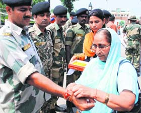 Sarabjits sister Dalbir Kaur ties rakhi to a BSF jawan at the Wagah border post on Wednesday