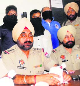 Police officials with seized drugs and smugglers arrested in Amritsar on Thursday