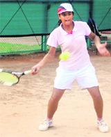A player returns a shot during a tennis match in Panchkula on Thursday.