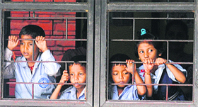 Dead flies and mosquitoes in a plate; and (above) children watch as residents shout slogans against the authorities at Government School, Colony No. 4, Chandigarh.