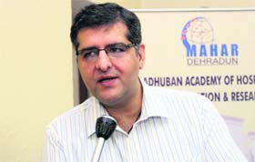 Hemant Kochar, Director of Mahar Institute of Hotel Management, addresses mediapersons in Dehradun on Thursday
