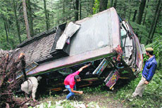 Police personnel and local residents look for injured persons in the bus that fell into a gorge near Chharabra, 12 km from Shimla, on Thursday. 