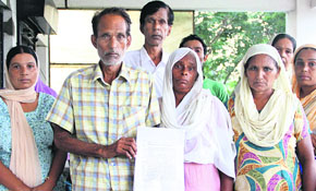 The parents of Vicky, who was recently murdered during a brawl, give a representation to police officials demanding a thorough probe into the murder case in Jalandhar on Thursday.
