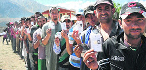 Voters standing in a queue to cast their vote in Tumail, near Kargil.