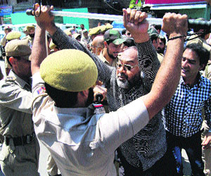Government employees scuffle with policemen during a protest to demand full implementation of sixth pay commission, in Srinagar on Thursday. 
