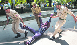Policemen drag a government employee during a protest in Srinagar on Thursday. Photo: Yawar Kabli 