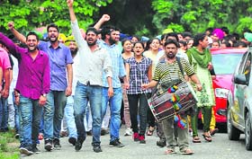 Students of Punjab Agricultural University raise slogans during a protest on the campus on Thursday