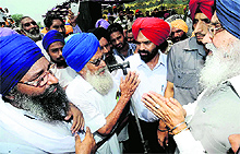Flood-hit farmers speak to Chief Minister Parkash Singh Badal in a Ferozepur village on Thursday