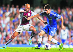 Chelsea's Oscar and Aston Villa's Karim El Ahmadi fight for the ball during their English Premier League match at Stamford Bridge in London on Wednesday.  Reuters