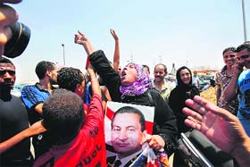 Supporters of deposed Egyption dictator Hosni Mubarak celebrate after his release in Cairo on Thursday