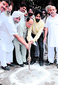 Municipal Commissioner DPS Kharbanda (in black turban) and Mayor Bakshi Ram Arora launch the water harvesting drive at MC office in Amritsar on Friday