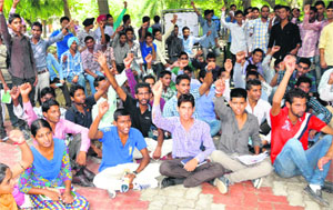 Students stage a protest against lack of teachers at Government Rajindra College in Bathinda on Friday.