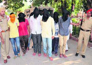 Police officials with the accused in Bathinda on Friday. 