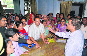 BJP councillors argue with the District Supply Officer over non-issuance of BPL and APL cards in Dehradun on Friday. 