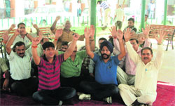 Government employees protest at the DC office in Jammu on Friday.