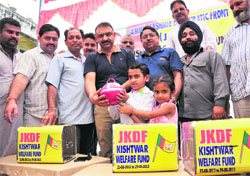 Members of the Jammu and Kashmir Democratic Front (JKDF) start a donation campaign, Kishtwar Welfare Fund, in Jammu on Friday. 