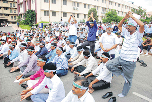Employees of Andhra Pradesh secretariat from Seemandhra protest against the bifurcation of the state in Hyderabad on Friday.