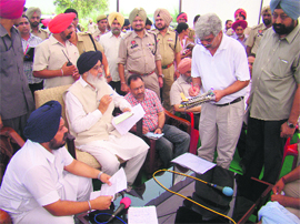 Dressing down? Chief Minister Parkash Singh Badal with the Chief Engineer (Drainage) at a Muktsar village on Friday.