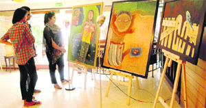 Visitors admire the paintings at Beyond August 15