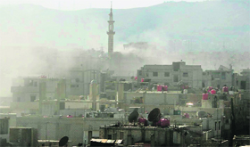 Smoke rises above buildings following what Syrian rebels claim to be a toxic gas attack near Damascus.