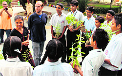 Tom Deiters and Om Sunisa of the Global Ecovillage Network encourage students to grow trees