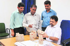 A team of the Jammu Municipal Corporation inspects samples of milk and cheese in Jammu on Saturday. 