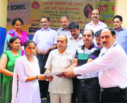 Bhumika Rajput receives the prize from the chief guest in Katra on Saturday. 