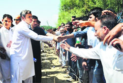 Chief Minister Omar Abdullah shakes hands with fruit growers during the inauguration of a fruit market at Subhanpora in Bijbehara in Anantnag district on Saturday.