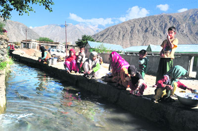  Residents of Kaksar village, 25 km from Kargil near the Line of Control, wash their clothes in dirty water. The village falls under firing range on the border and lacks tap water facility.
