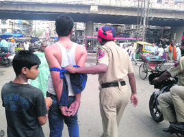 A policeman takes Sarabjit to police station in Ludhiana on Saturday.