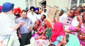 Chief Minister Parkash Singh Badal meets the flood-affected people at Bamm village in Muktsar district on Saturday.