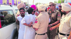 Policemen try to control the situation as rival Akali Dal factions clash at a Muktsar village on Saturday.