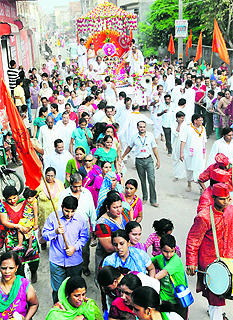 devotees participate in a Rath Yatra