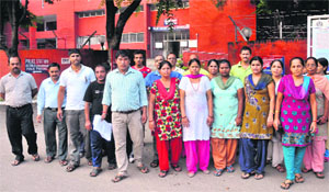 Members of the Nepalese community gather in front of the Sector 3 police station in Chandigarh on Sunday.