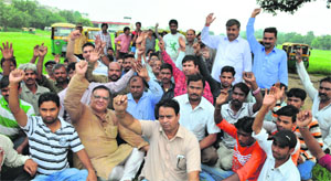 Members of the Tricity Auto-rickshaw Union protest at Sector 34 in Chandigarh on Sunday. 