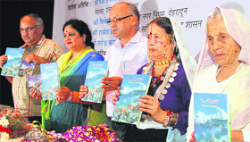 Uttarakhand Tourism Minister Amrita Rawat (second from left) releases a book written by famous jagar singer Basanti Bisht (second from right) at a function in Dehradun on Saturday.