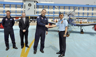 A senior IAF officer shakes hands with a Swiss pilot after the arrival of the first Pilatus PC - 7 (below left) at the Air Force Academy, Dundigal near Hyderabad earlier this year.