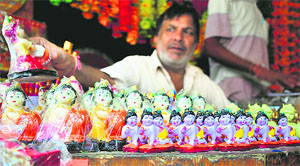 Idols of Lord Krishna on display at a shop of the Pacca Danga market in Jammu.