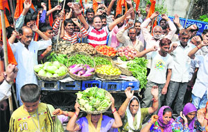 Activists of the Dogra Front and the Shiv Sena protest against the vegetable price hike in Jammu on Sunday.
