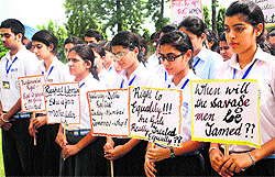 Schoolchildren hold placards to protest against the Mumbai gang-rape incident, in Jalandhar