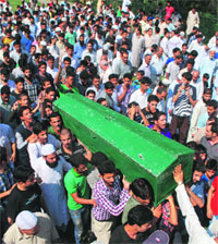 People carry the coffin of Farooq Azam Khan at Patilpora in Chatabal locality of Srinagar on Sunday. 