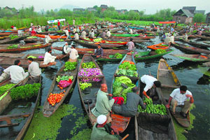 Vendors sell vegetables in their boats in the Dal Lake in Srinagar on Sunday.